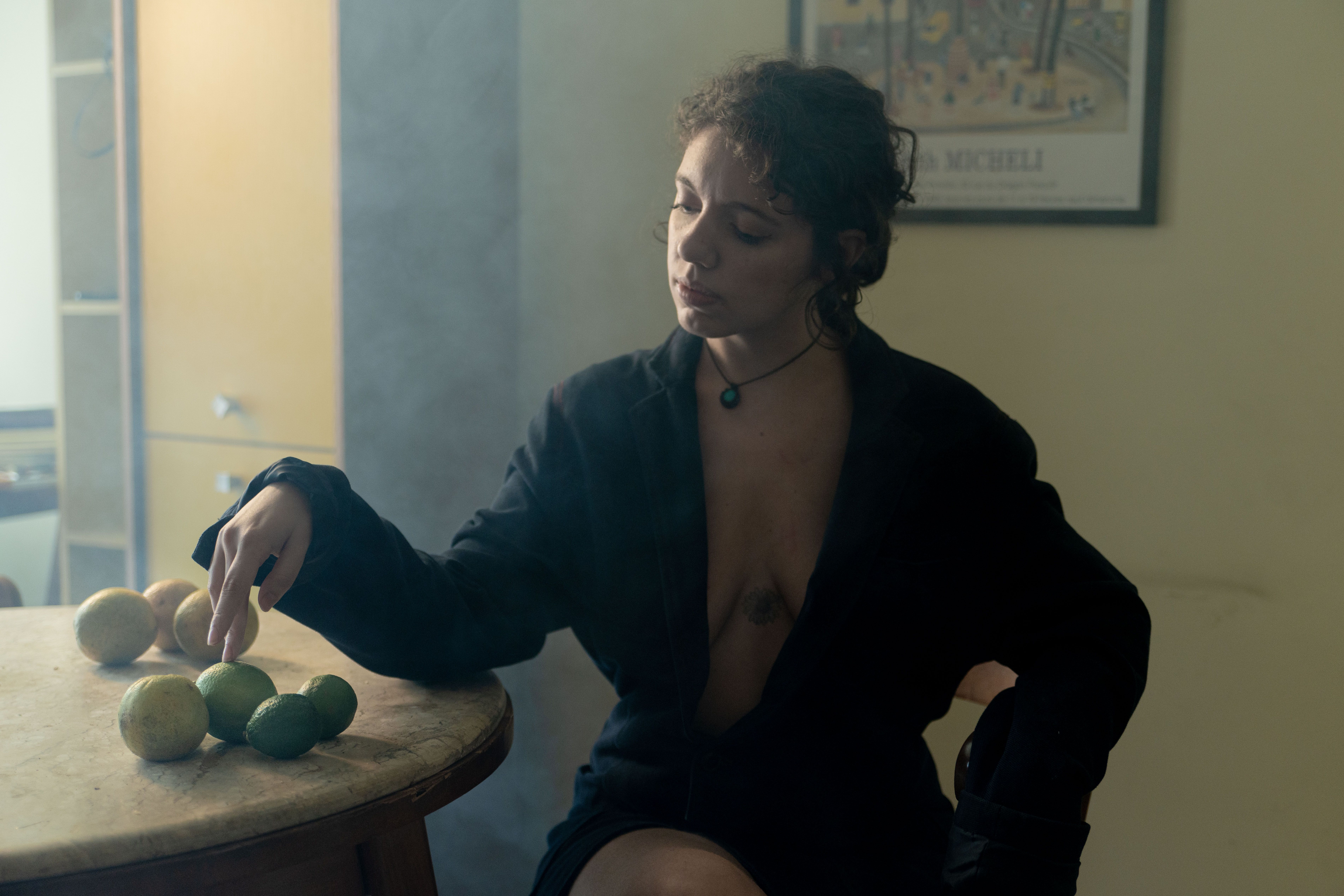 Artistic portrait of a woman indoors, setting an introspective tone.