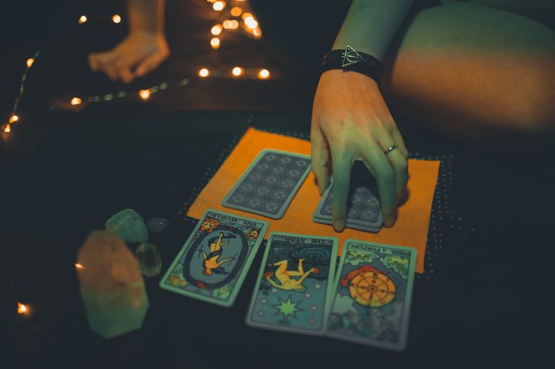 Tarot cards spread on a dark table during a reading session