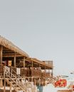 Wooden thatched beach constructions in sunlight