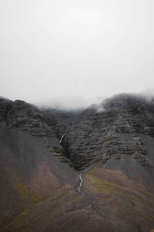 Free Amazing distance view of rocky mountains with fog on tops and narrow river line flowing along ridge Stock Photo