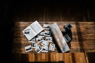 Photos and journal with map and camera on wooden table