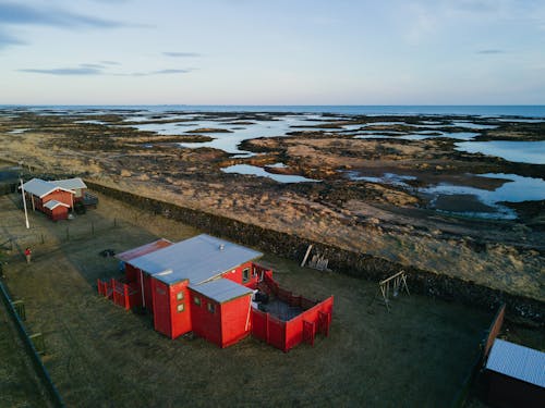 Small village on empty ocean coast against cloudless sky