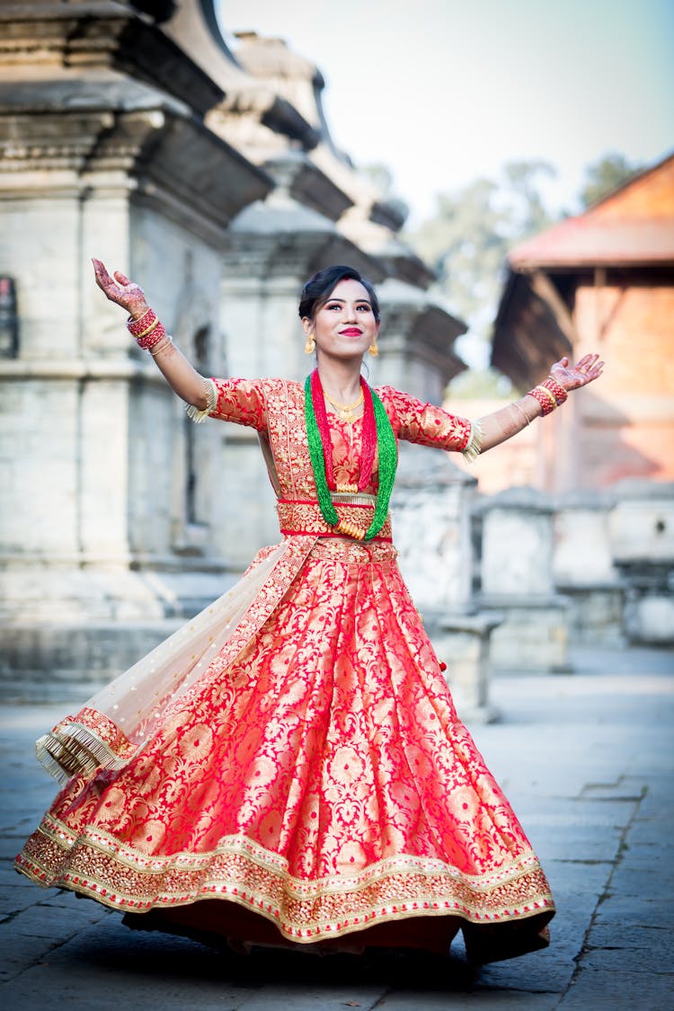 A Woman Wearing A Red Saree Dress