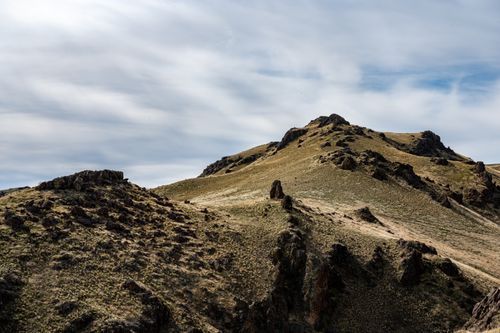 Free Mountainous landscape of high rocky rough steep peak under cloudy sky at daytime Stock Photo