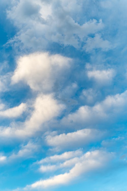 Abstract background of white clouds floating over blue bright sky in sunny day