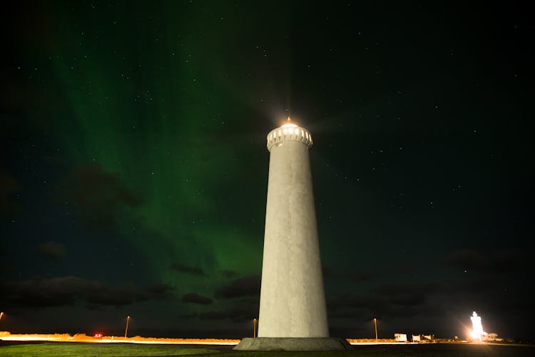 Northern Lights Over Lighthouse Against Night Sky