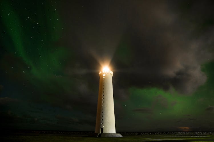 Lighthouse Tower In Cloudy Night