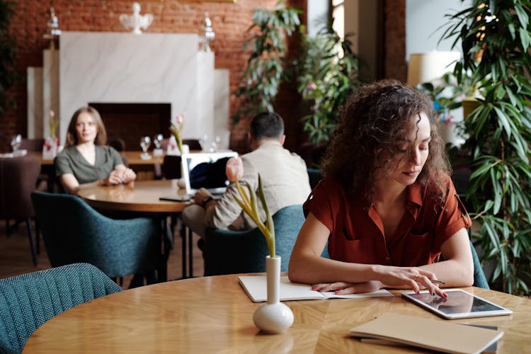 Woman Working While At The Restaurant