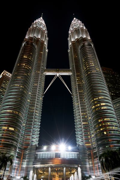Modern city skyline with twin towers at sunset