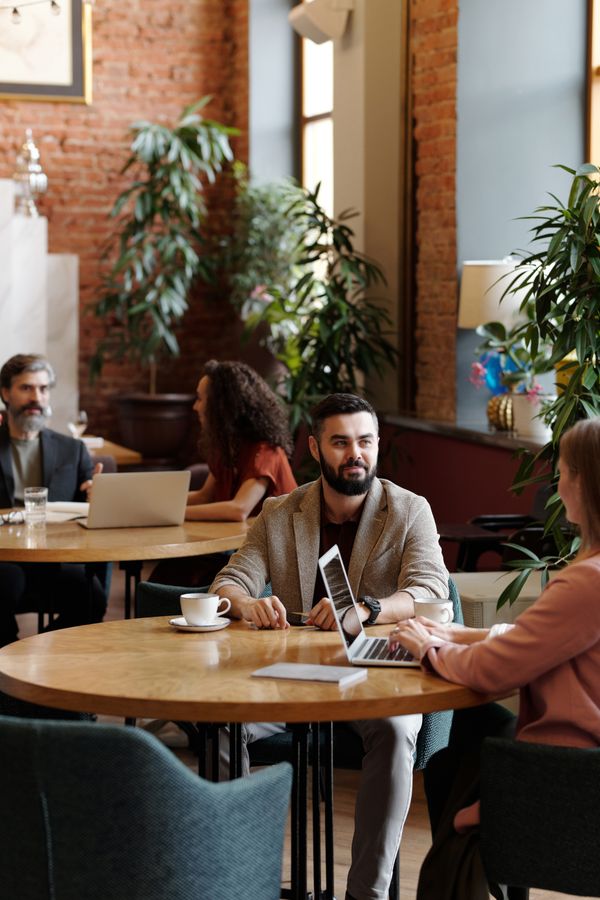 Colleagues working from a neighbourhood cafe — photo by Edmond Dantès on Pexels