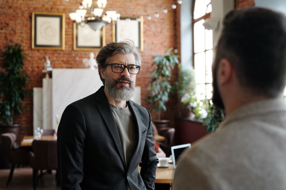 Senior man in suit with beard and eyeglasses in a business setting. Senior man in suit with beard and eyeglasses in a business setting.
