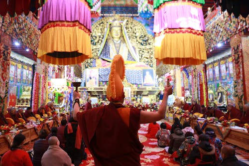 Buddhist monarch in temple with people
