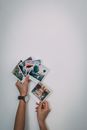Person Holding White and Green Floral Card