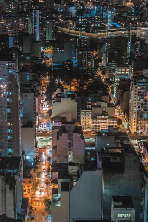 Free A bustling cityscape illuminated at night, showcasing vibrant urban energy and modern skyscrapers. Stock Photo
