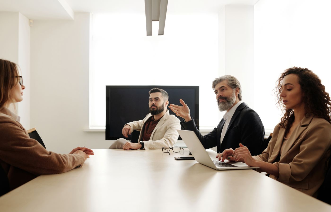 Professional team engaged in a business meeting discussing strategy in a modern office environment.