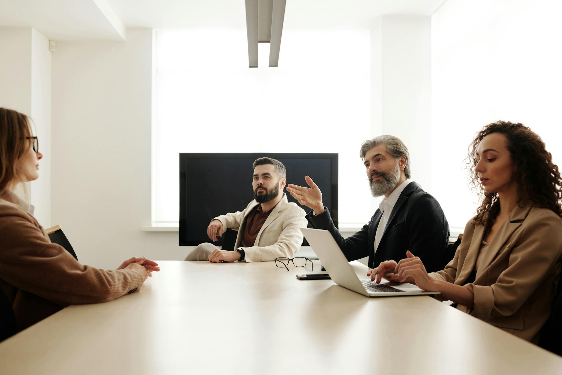 A Group of People Sitting at the Table at a Business Meeting