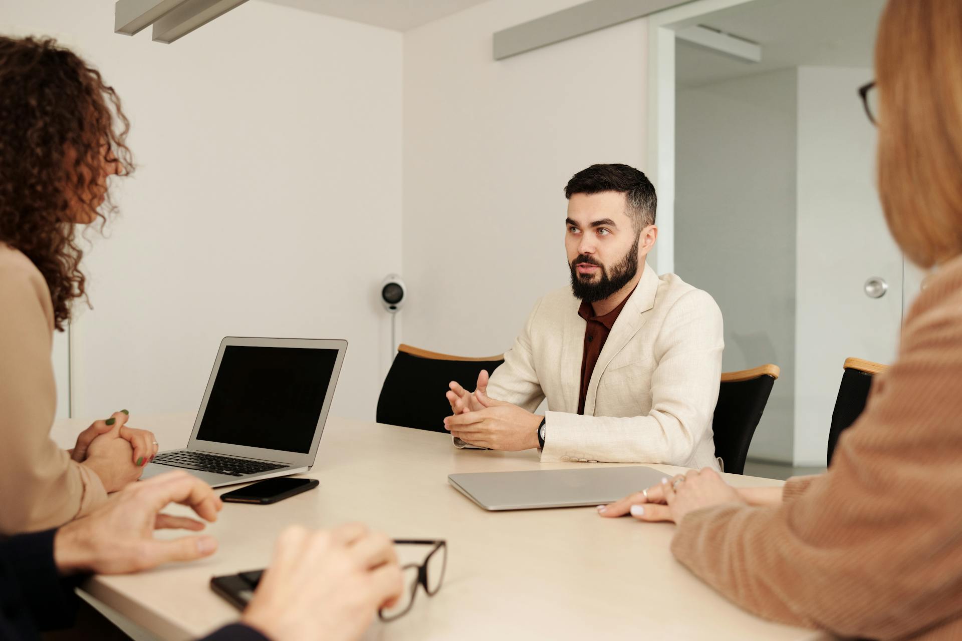 Business professionals engaging in a collaborative meeting in a well-lit office setting.