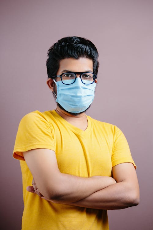 Man in Yellow Shirt Wearing a Surgical Face Mask