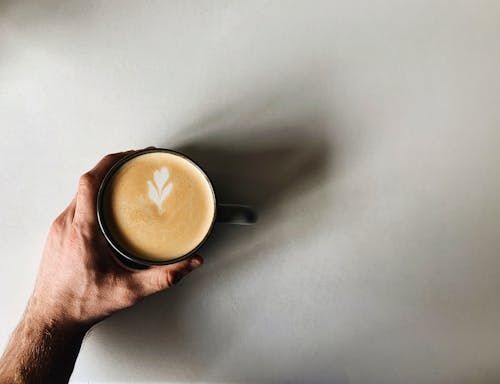 Free Person Holding a Cup of Cappuccino  Stock Photo