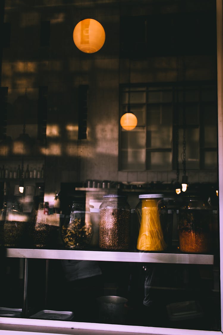 Jars Of Condiments On Shelf In Coffee Shop