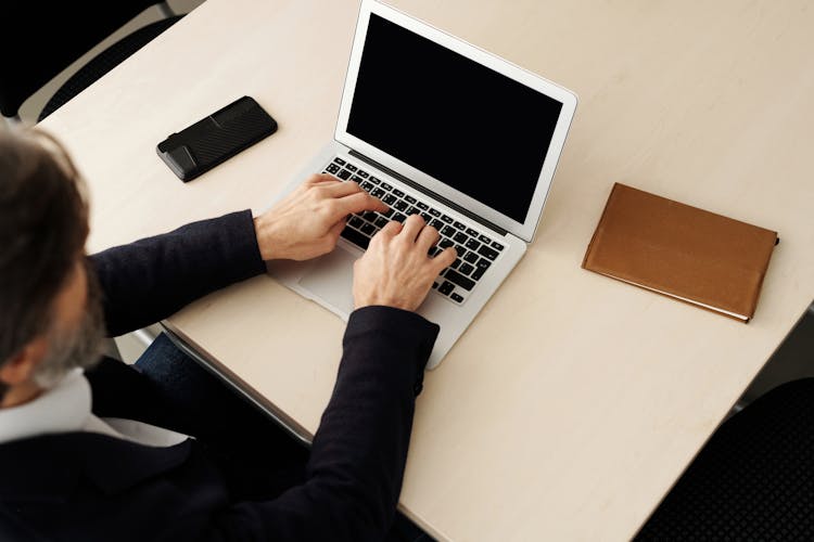 Photo Of Person Using A Laptop