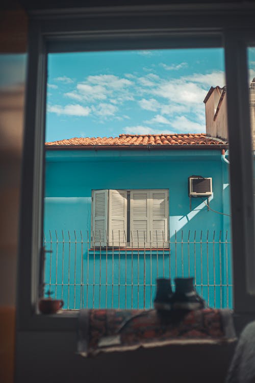 Free Blue House Seen Through Open Window Stock Photo