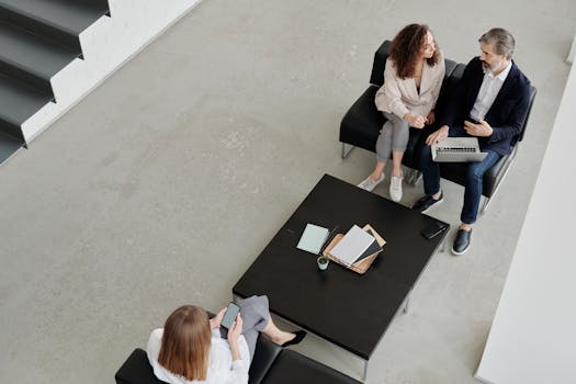 Top view of colleagues collaborating in a sleek, modern office setting.
