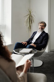 Colleagues discussing business strategies in a sleek, modern office setting.