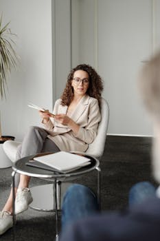 A professional woman in an office setting conducting an interview with confidence.