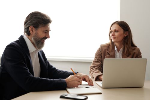 Free Two colleagues engaged in a business discussion in a modern office setting. Stock Photo
