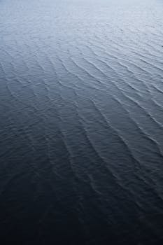 Relaxing image of deep blue ocean water ripples, perfect for backgrounds and textures.