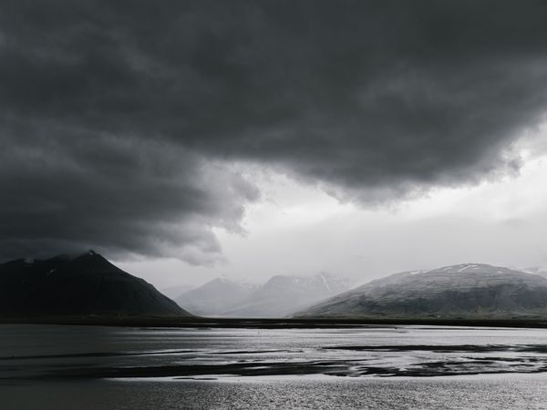 Storm clouds over a mountain lake — photo by ArtHouse Studio on Pexels