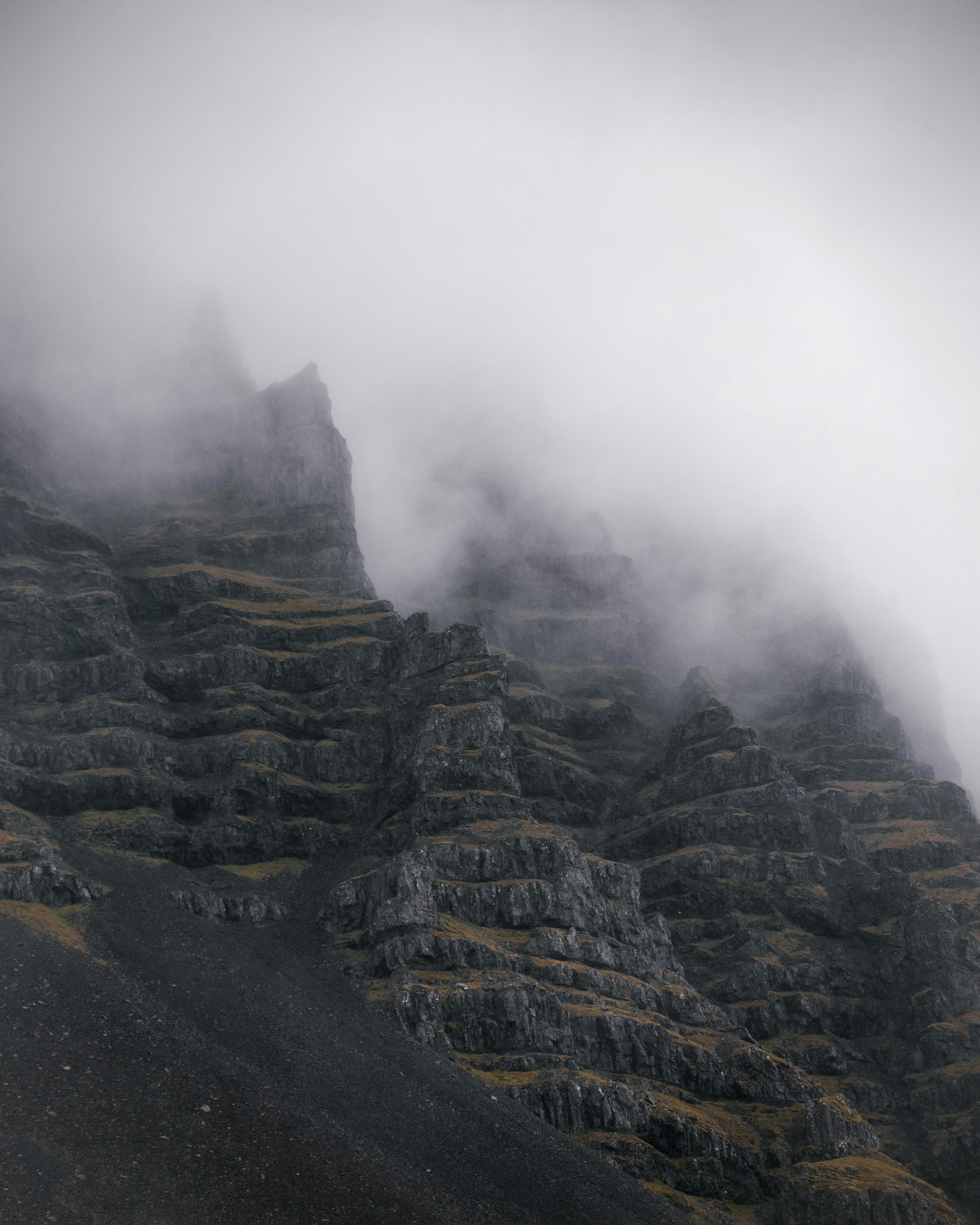 Dramatic mountain ridge with peaks in cloudy sky · Free Stock Photo