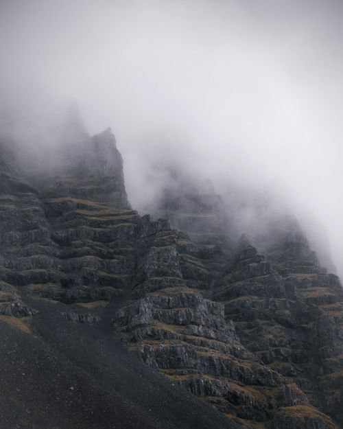 Free Magnificent view of rocky mountain range with rare greenery located against cloudy overcast sky Stock Photo