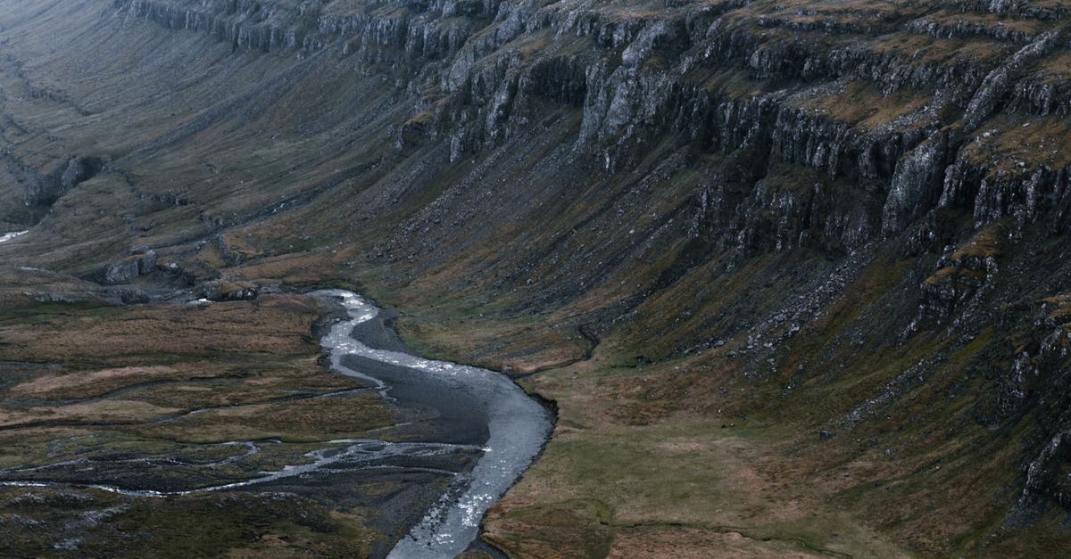 Wide Ravine Rocky ravine with narrow curvy river · Free Stock Photo