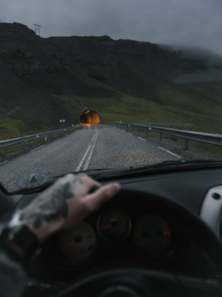 Crop Driver Driving Into Tunnel In Mountain Slope