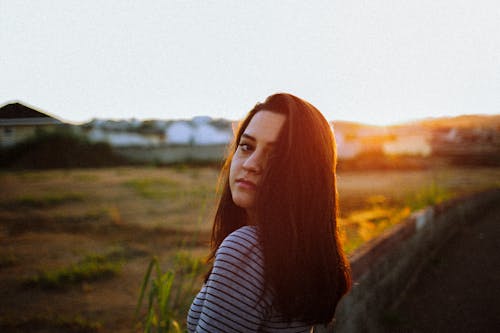 A Woman in Black and Gray Striped Long Sleeve Shirt 