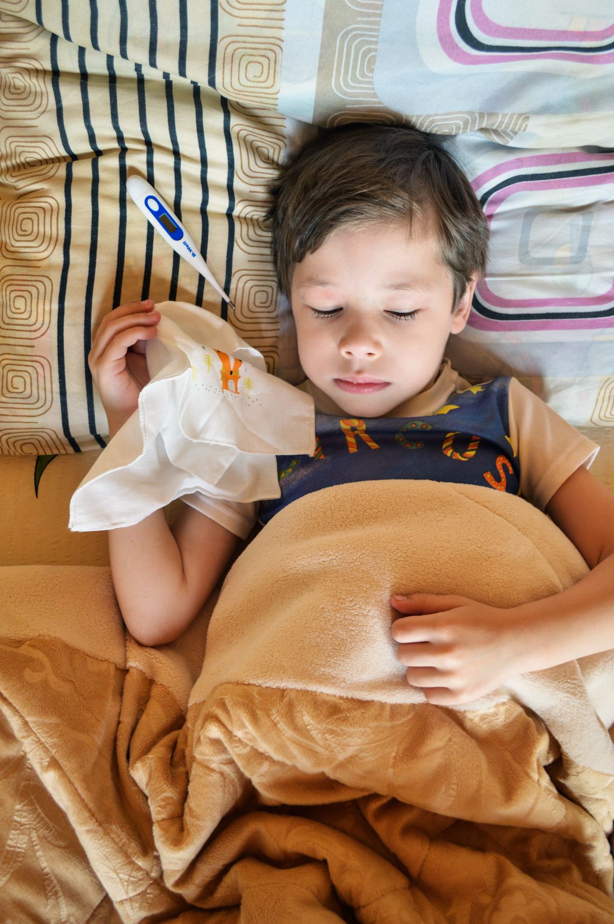 Child resting in bed during recovery from pneumonia
