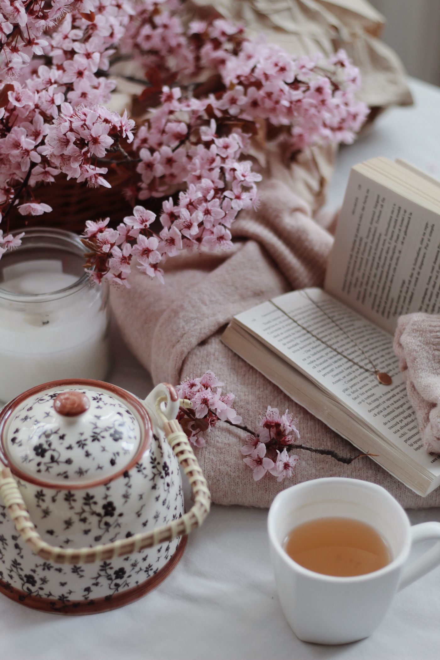 Tazza di tè, libro aperto e fiori in un ambiente rilassante