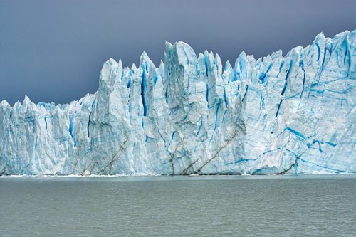 Free Amazing landscape of huge blue glacier in calm sea in winter on background of gray sky Stock Photo