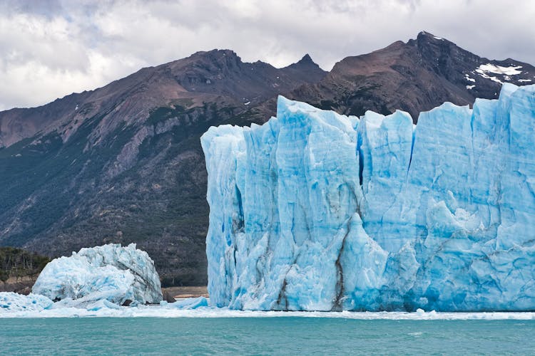 Rough Glacier In Front Of Mountain In Winter