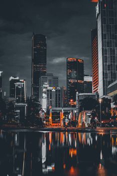 Captivating night view of Jakarta skyline with glowing reflections in urban setting.