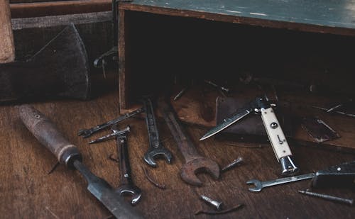 From above of set of various carpentry tools arranged on lumber table in workshop