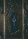 Tools and wristwatch placed in wooden box