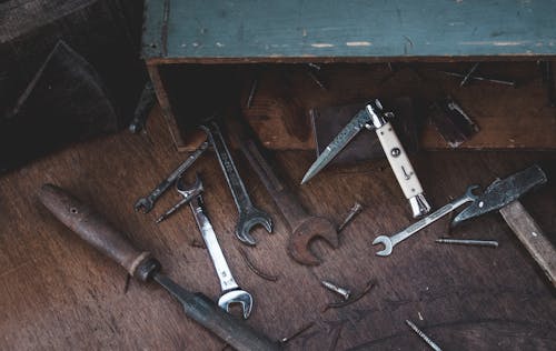 Free From above of various carpentry tools arranged on wooden table near box in workshop Stock Photo