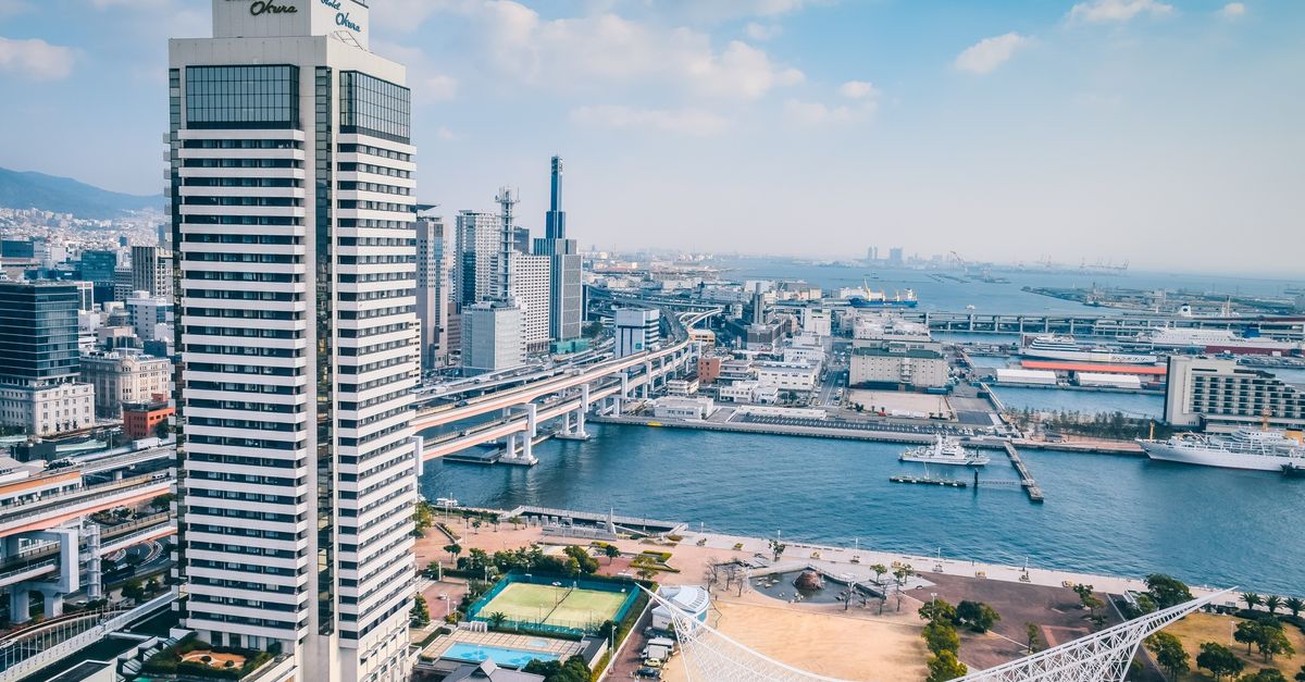 Elevated view of Kobe cityscape featuring modern architecture along the waterfront.
