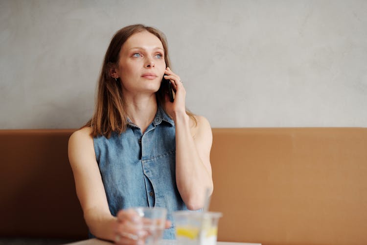 Woman Talking On A Phone In Cafeteria