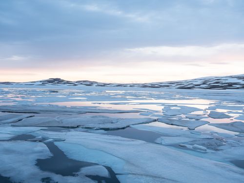 Free Majestic severe nordic landscape with winter river under ice in early spring against cloudy blue sky Stock Photo
