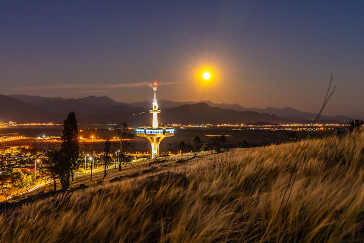 Television Tower Under Glowing Sun At Night