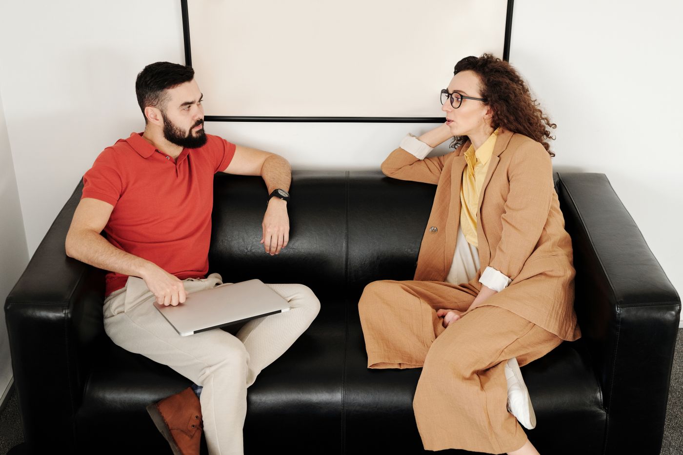 Two people in conversation on a sofa